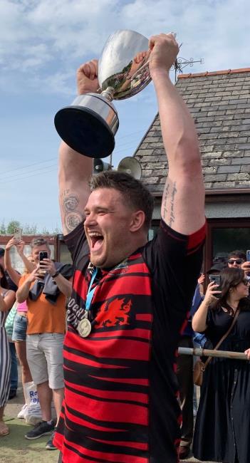 Skipper Luke Dedman clearly thrilled to raise the cup aloft